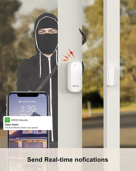 Security camera notification on phone app while intruder in black mask attempts break-in, illustrating real-time alerts.