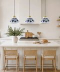 SIMEESO Ceramic Pendant Light in a kitchen setting with blue and white porcelain and gold accents over an island.