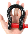Hand holding a 2 Pack 0.75 Inch D Ring Shackles Beefy Heavy Duty Forged Steel Screw Pin Shackles WLL 4.75T Built For Tractors Trucks Winches
