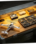 Worktable with tools and model aircraft featuring Beefy Carbon Fiber Rods 1.64 ft Long 0.08 in Diameter, 10 Pack Black Round Bar.