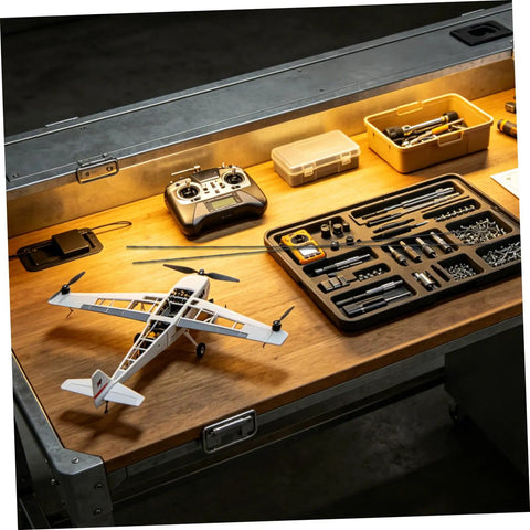Worktable with tools and model aircraft featuring Beefy Carbon Fiber Rods 1.64 ft Long 0.08 in Diameter, 10 Pack Black Round Bar.