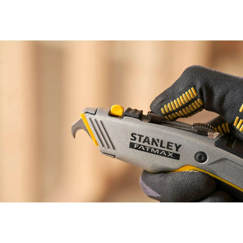 Gloved hand holding 2 In 1 Snap Off Knife Xtreme With Stainless Steel Blade Guide 9mm Width Quick Blade Change Via Notched Wheel