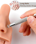2 Pack Piercing Ball Grabber Tool For Changing Jewelry held near earring on silicone ear model, stainless steel handle