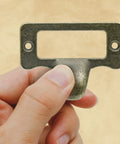 Antique Bronze Card Catalog Drawer Pulls Set Of 20 For File Cabinets Office Furniture, held by hand, showing zinc alloy construction.