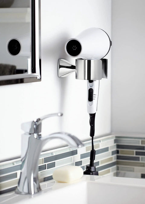 Voss Hair Dryer Holder Wall Mount In Bronze Finish Coordinates With Voss Faucets And Bath Accessories Includes Mounting Hardware For Easy Installation No Fuss Setup Crisp Edges And Fashionable Modern Bathroom Accessory with hair dryer mounted near sink.