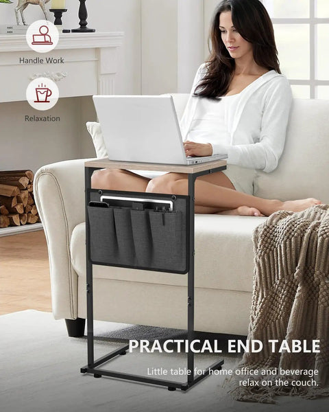 Woman using C Shaped End Table For Couch And Recliner With Under Sofa Sliding Laptop Tray And Storage Pockets, Greige Finish