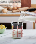 Pouring milk into Borosilicate Glass Measuring Cup 1 Cup 8oz with Spout Your Go To Liquid Measuring Tool For Cooking And Cocktails