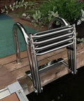 Folding Dock Boat Ladder 4 Step Heavy Duty Stainless Steel Marine Yacht Ladder with Swim Deck on dock, folded position.