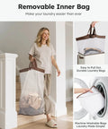 Woman carrying Big Ol 100L Large Laundry Basket With Removable Bag And Lid, Collapsible Hamper For Bedroom Dorm, off white color.