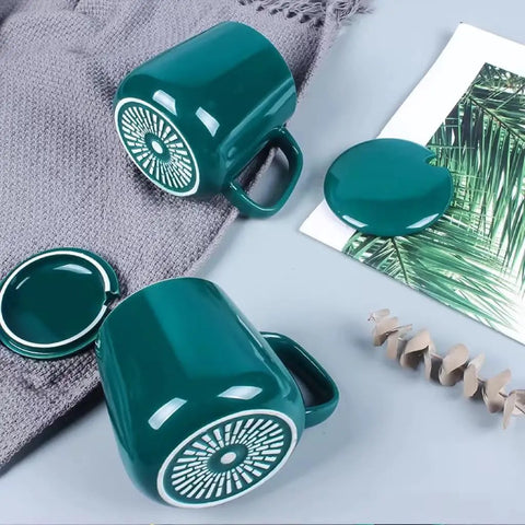 Skip The Lukewarm Sip With This Smart Electric Coffee Mug Warmer Set featuring teal ceramic mugs with decorative lids.