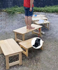 Series of wooden tables with a person standing on one, showcasing Two Pack 90 Degree Self-Locking Folding Hinge Lock Steel Foldable Bracket.