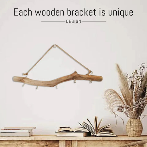 Badass 16 Inch Natural Wood Wall Hooks Featuring Five Curved Prongs For Hanging Heavy Jackets Tote Bags And Key Chains Inside Your Mudroom Or Entryway While Keeping Everything Slick And Organized, displayed on a wall with decorative items.
