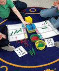 Children using Base Ten Blocks Place Value Mat Set For Kid Friendly Hands On Math Learning With 10 Piece Manipulatives For Kindergarten First And Second Grade Classrooms And Homeschool Activities on a colorful mat.