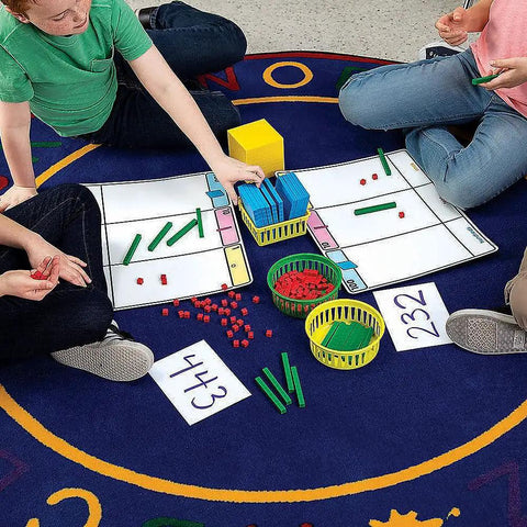 Children using Base Ten Blocks Place Value Mat Set For Kid Friendly Hands On Math Learning With 10 Piece Manipulatives For Kindergarten First And Second Grade Classrooms And Homeschool Activities on a colorful mat.