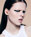 Person wearing Experience 2 Ear Plugs For Concerts And Festivals, High Fidelity 17dB Noise Reduction, rose gold color