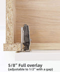 Side view of a metal 5/8-inch full-overlay concealed cabinet hinge mounted on a light wood kitchen cabinet door