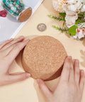Hands holding Large Cork Stoppers 4.1 to 4.7 Inch Bottle Corks, Tapered Wooden Plugs For Canning Jars on table with flowers