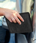 Person using Super Absorbent Microfiber Car Drying Towel Thickened Lint Free Auto Wash Cloth on car surface for drying.