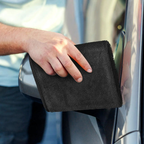 Person using Super Absorbent Microfiber Car Drying Towel Thickened Lint Free Auto Wash Cloth on car surface for drying.