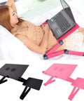 Premium Aluminum Laptop Bed Tray With Adjustable Angled Legs And Cooling Radiating Vents Built Tough Hassle Free Portable Folding Workstation Desk For Relaxed Daily Grind used for laptop support while lying on a sofa.