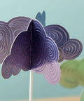 Purple layered paper flower craft on a stick with swirl debossed patterns