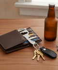 Metal Card Multitool With Bottle Opener, Flathead Screwdriver, And Hex Adjuster for Wallet or Keychain Everyday Carry on table