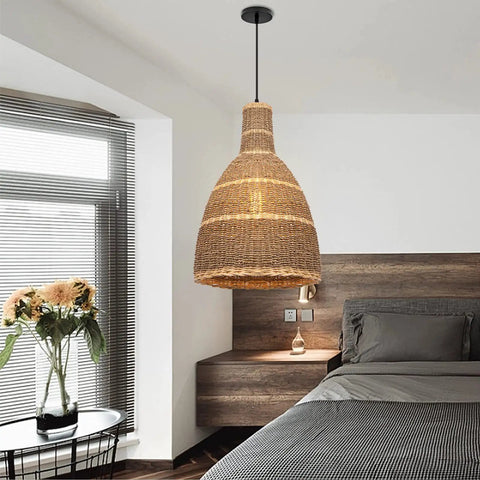 One Light Farmhouse Pendant Light In Natural Rattan And Seagrass hanging in a modern bedroom for a cozy rustic vibe.