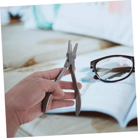 Hand holding Stainless Steel Eyeglass Repair Pliers With Nose Pad Tool 2 Piece Glasses Maintenance Kit for Quick Adjustments and Fixes