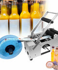 No Sweat Semi Automatic Round Bottle Labeler High Speed Applicator For Cylindrical Containers Adjustable Paper Roll Tray with labels on bottles.