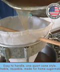No Sweat Maple Syrup Tapping Kit For Trees With Ten Tough Three Foot Blue Drop Tubes Spiles One Quart Sap Filter pouring syrup.
