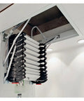 Pro Grade Electric Heavy Duty Retractable Attic Ladder With Hella Tough Aluminum Frame partially deployed from ceiling hatch.
