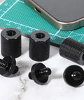 Six Pack 1/4 Inch To 1/4 Inch Threaded Tripod Screw Adapter, aluminum mounts on green cutting mat with smartphone.