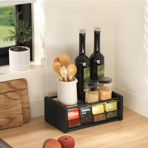 Kitchen organizer with spices, bottles, and utensils on countertop next to window and cutting board