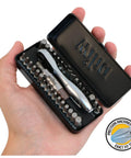 Hand holding a black 35 Piece Bit Ratchet Compact Storage Box Set With Slotted And Phillips Bits Square Torx And Hex 1/4 Inch Hex