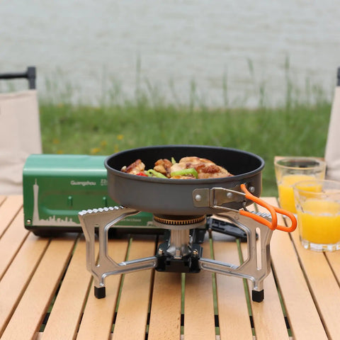 Portable Butane Gas Camping Stove With 7500 BTU Output Ultra Compact Folding Design With Carry Bag For Backpacking RV Trips Picnics And Outdoor Or Indoor Cooking Green on wooden table.