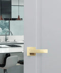 Sleek modern kitchen with door featuring a Six Piece Satin Brass Gold Door Handle Set With Passage Levers Without Lock For Interior Doors Built To Last Heavy Duty Levers For Hallways And Closets Adjustable Latch Two And Three Eighths Inches Or Two And Three Quarters Inches.