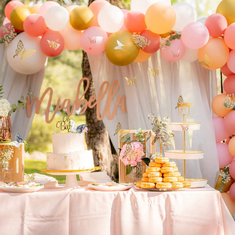 180 Pcs 3D Butterfly Wall Decor Kit in gold, silver, rose gold on event dessert table with balloons and cake at outdoor party.