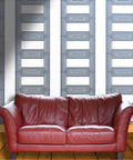 Top Tier Textured Peel And Stick Wallpaper Roll Thick Durable Vinyl Wallcovering Eco Friendly Self Adhesive Backing Light Shades on walls behind a red leather sofa.