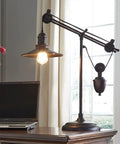 Urban Industrial 29.5 Inch Metal Desk Lamp With Adjustable Arm And Shade Bronze Finish beside laptop in home office