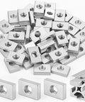 Real Deal M8 Sliding T Nuts For 4040 Aluminum Extrusion Bulk Pack Of 50 Zinc Coated Steel Block Fasteners arranged in a pile.