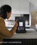 A user interacting with the Kick Back And Sip Perfection With This Ultra Quiet Fully Automatic Bean To Cup Coffee And Espresso Machine.