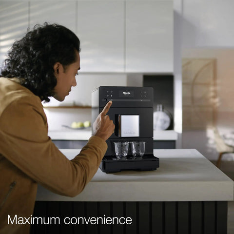 A user interacting with the Kick Back And Sip Perfection With This Ultra Quiet Fully Automatic Bean To Cup Coffee And Espresso Machine.