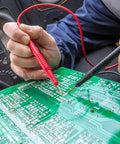Hands using Flexible Multimeter Test Lead Kit With CAT III 1000V 10A Safety, Boss Quality Gold Plated 4mm Probes on circuit board