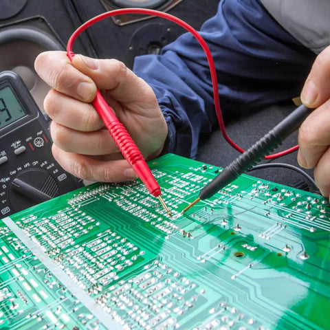 Hands using Flexible Multimeter Test Lead Kit With CAT III 1000V 10A Safety, Boss Quality Gold Plated 4mm Probes on circuit board