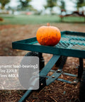 Garden cart with 10 Inch Flat Free Solid Tire And Wheel Replacement 4.10/3.50-4 carrying a pumpkin, showcasing dynamic load-bearing capacity.