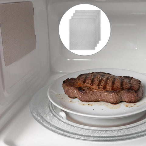 4 Pc Waveguide Cover Replacement Kit With Scissors, 150Mm By 120Mm Mica Plates Sheets shown in a microwave next to cooking steak.