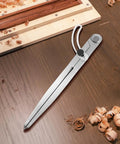 Heavy Duty Six Inch Alloy Metal Compass Scribe Dead Nuts Accurate Layout Divider on wooden surface with shavings.