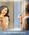 Woman applying makeup with 65.6ft Warm White LED Strip Lights Kit With Dimmable 24V Power Supply on vanity mirror reflecting light