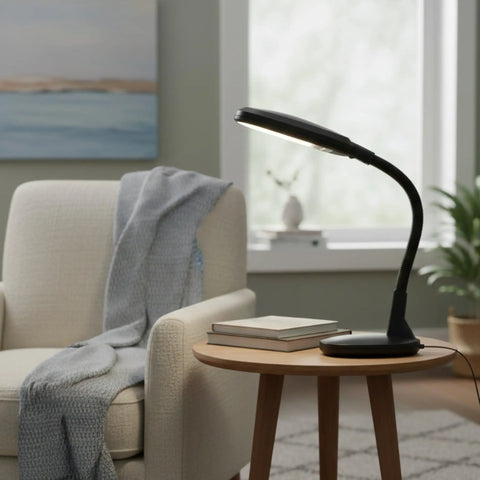 Natural Daylight Desk Lamp With Adjustable Gooseneck For Reading Working Crafting Sewing Or Homework Eye Strain Relief 6400K 27W Light For Dorm And Office Black next to a chair in a cozy room setting.
