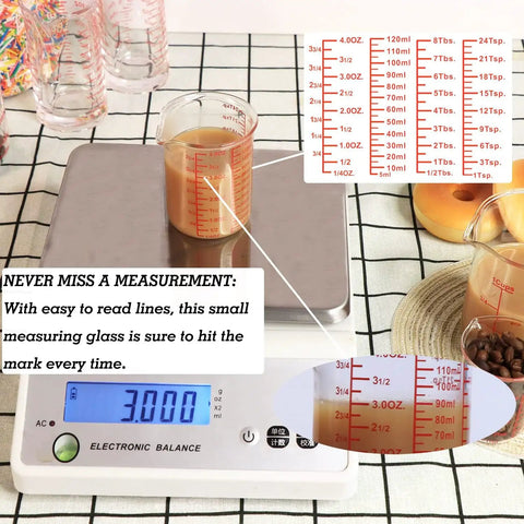 Seven Piece Glass Measuring Cup Set With Borosilicate Beaker Style Nesting Cups, Clear Markings From 1 Tsp To 8 Oz, Your Kitchen Go To For Baking, Cooking And Drink Prep, Durable Glass Easy To Read. Borosilicate glass beaker cup with clear red markings on a scale